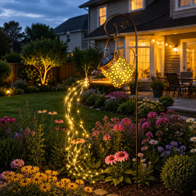 A waterproof metal solar watering-can lantern hangs outdoors with LED cascading lights for patio, yard, lawn, or pathway decor and works as a birthday or gardening gift for women, Mom, or Grandma.
