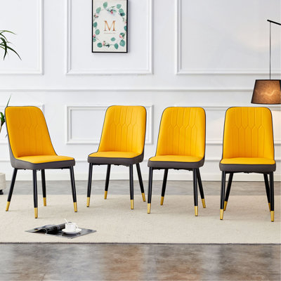 Une chaise de salle à manger moderne avec un dossier en cuir de polyuréthane bicolore jaune et gris foncé et des pieds en métal noir, idéale pour les cuisines, les chambres et les bureaux. Ensemble de 4 pièces (jaune orange, gris foncé + polyuréthane)
