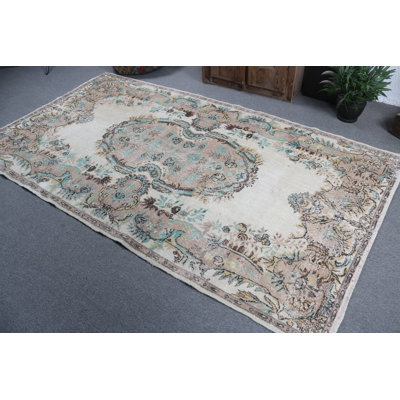 Experience the Charm of a Classic Turkish Area Rug with Beige Floral Patterns