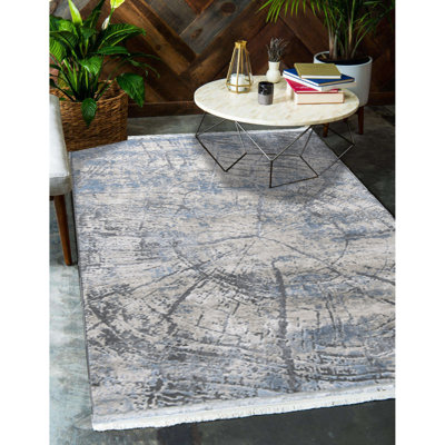 Tapis en acrylique tissé à la machine à motif abstrait Crescent en beige / gris / bleu