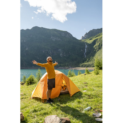 Man Outside Tent Stretching Arms Out by Mystockimages - No Frame Art Prints on Canvas