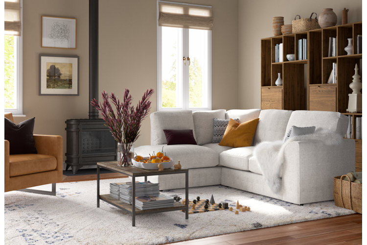 modern vintage style living room with a modern white sofa a modern style accent chair and a vintage style woodstove, coffee table and decor