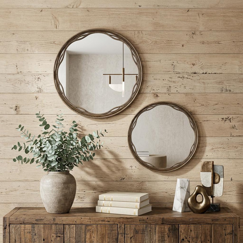 Ensemble de deux miroirs décoratifs ornés de cadres ronds dorés
