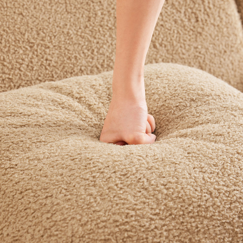 Fauteuil sans os Camel, doté d'un design ergonomique et d'accoudoirs incurvés, avec une base en tissu confortable, conçu pour le salon.