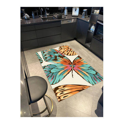 Tapis décoratif moderne à motif papillon abstrait turquoise