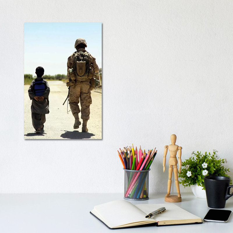 Rear View Of Us Marine Walking Through Nawa Bazaar With An Afghan Boy In Afghanistan by Stocktrek Images - Wrapped Canvas Gallery-Wrapped Canvas Giclée