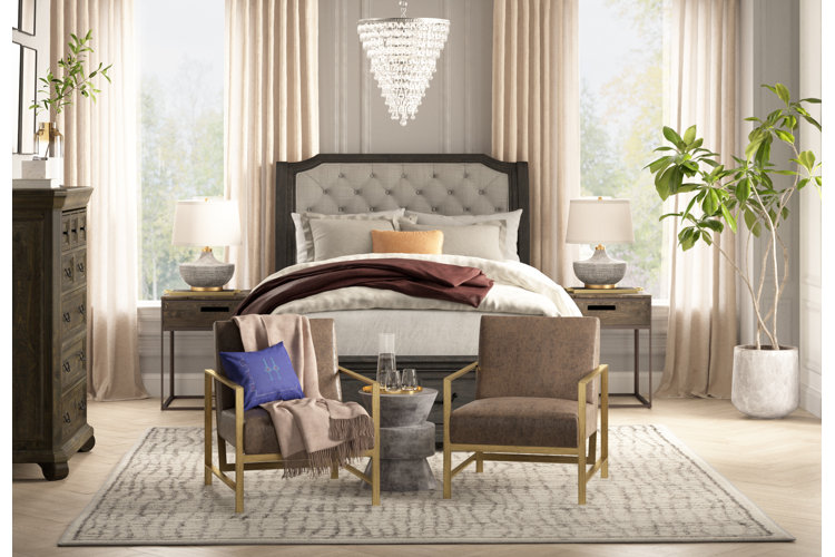 bedroom with throw blankets over bed and chair