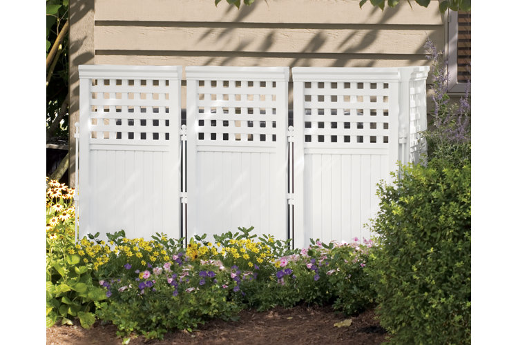 white fence with lattice border in a flower garden
