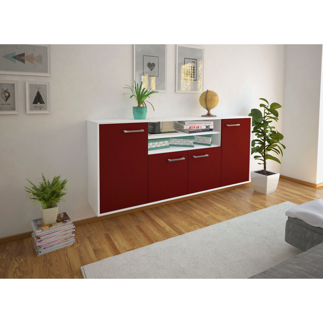 Das Sideboard Mesquite ist in Rot und Weiß gehalten. Es hat ein fliegendes Design und Metallgriffe.