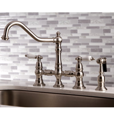 Kingston Brass Restoration Two-Handle 4-Hole Deck Mount Bridge Kitchen Faucet with Brass Side Sprayer