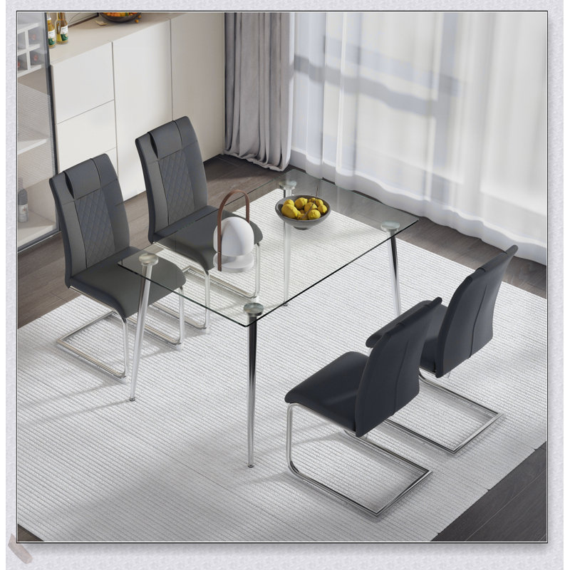 Ensemble de table de salle à manger élégant en verre et chaise grise, parfait pour les maisons contemporaines et les expériences culinaires élégantes