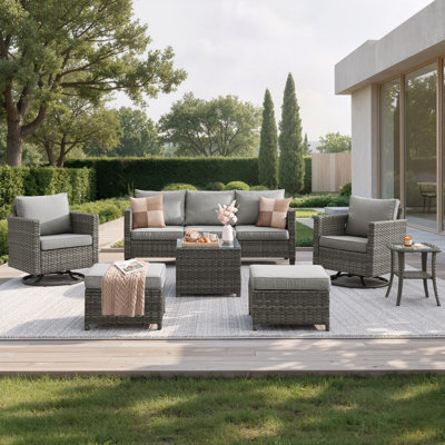 Ensemble de conversation extérieur en résine tressée 7 pièces avec fauteuils à bascule pivotants, poufs, coussins et table basse en verre