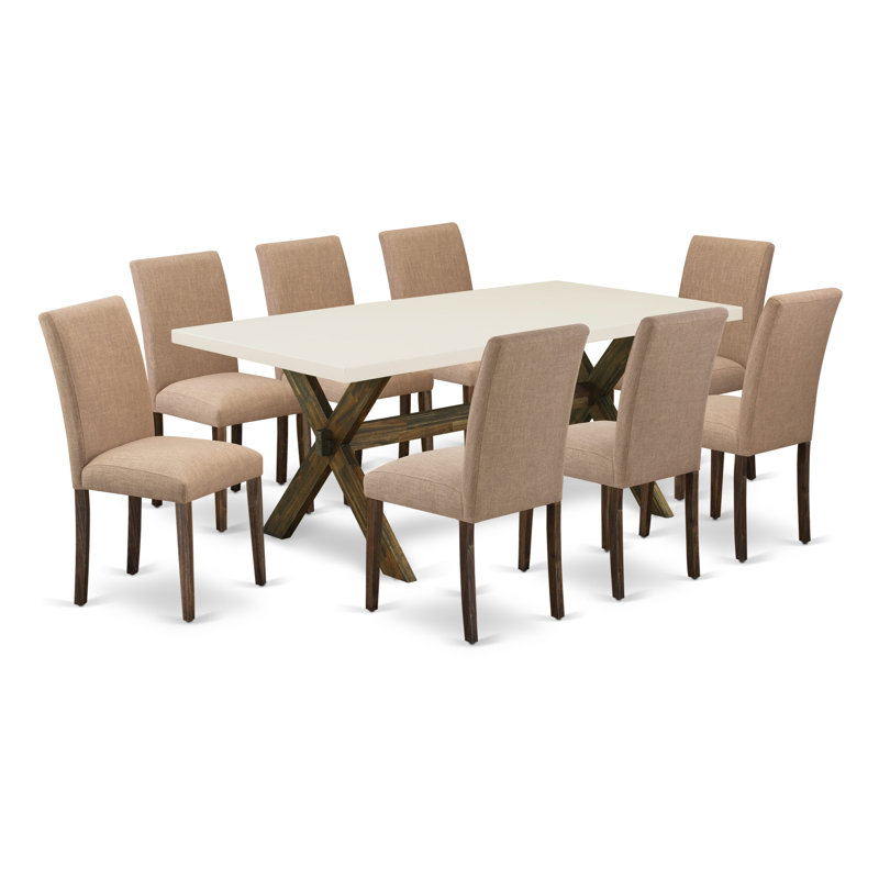Cet ensemble de salle à manger 9 pièces comprend une table de salle à manger rectangulaire avec pieds en X et 8 chaises Parson rembourrées en tissu de sable sable