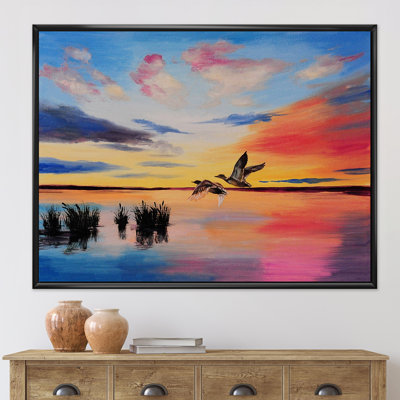 Grues volant pendant un coucher de soleil coloré - peinture sur toile