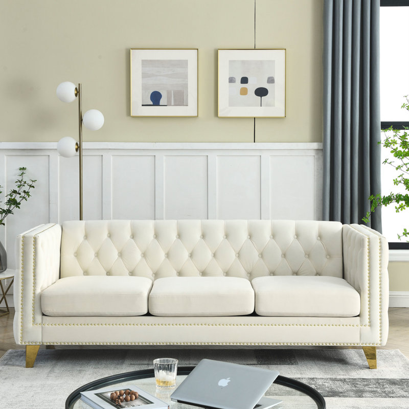 Canapé de salon moderne: revêtement en velours avec capitonnage et base en métal