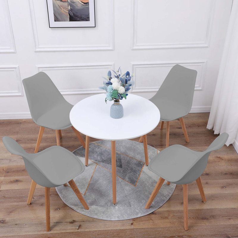 Christy 4 Person Dining set - a Round Plastic Dining Table with Wooden Legs and a Set of 4 Faux Leather Cushion Padded Dining Chairs for Dining Room - Modern Dining Table Set