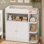 Commode à langer pour chambre de bébé, table à langer pour bébé avec grande armoire, 4 tablettes ouvertes et boutons en cristal (plateau à langer inclus, coussin à exclure)