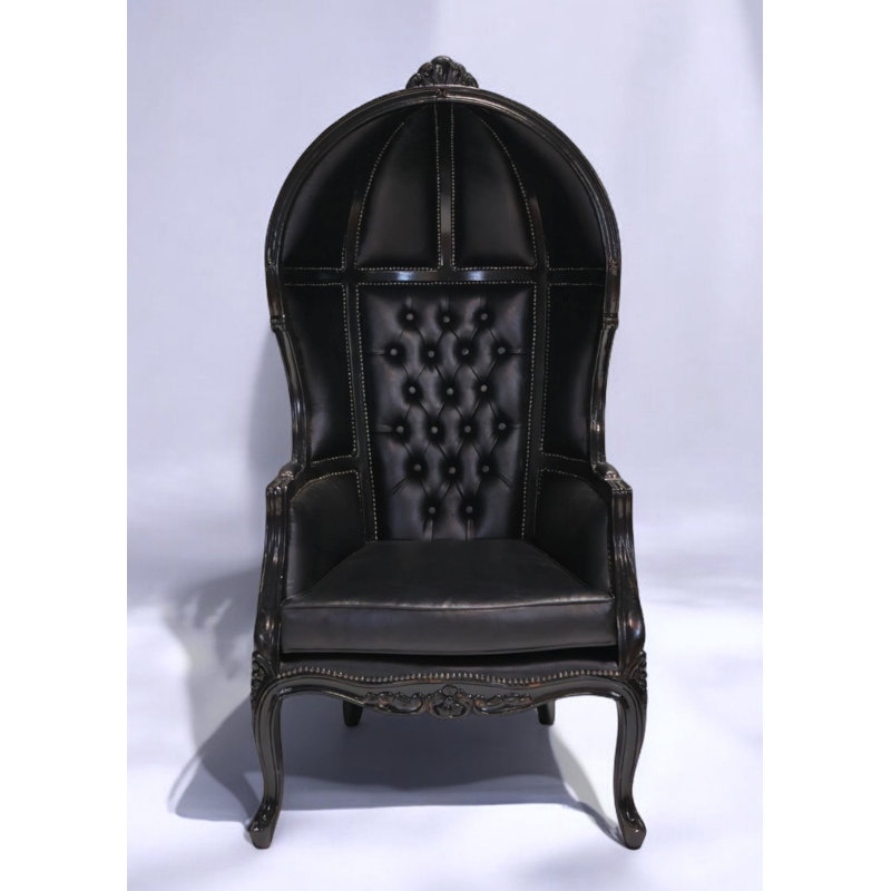 Fauteuil capitonné en similicuir noir capitonné