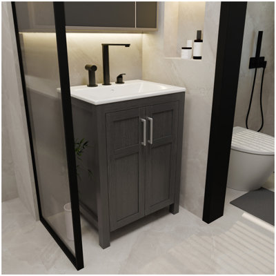 A 24-inch black bathroom cabinet, paired with a white ceramic basin, has a modern design and is made of materials that are waterproof and durable.