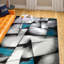 Tapis noir / bleu sarcelle à motif abstrait Crosland-27718789