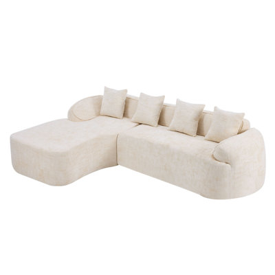 Beige Chenille L-Shaped Compressed Sofa That Goes Well With Any Living Room. It Features High-Elastic Sponge For A Comfortable Sitting Feel,  Curved Armrests And Four Throw Pillows.