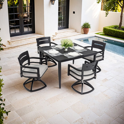 Ensemble repas d'extérieur avec table rectangulaire et chaises berçantes pivotantes avec coussins Sunbrella