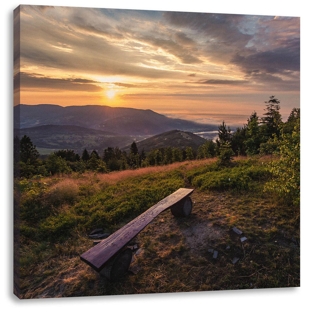 Leinwandbild Bank auf dem Berggipfel bei Sonnenuntergang