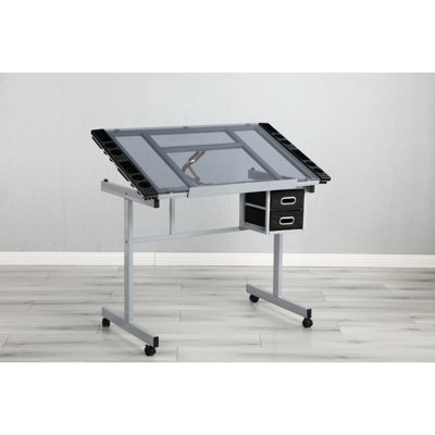 Table à dessin réglable, plateau de 0 à 70 degrés, 2 tiroirs en tissu, 4 roues universelles silencieuses, surface en verre transparent, structure en acier thermolaqué, gris argenté, largeur de 23,46 po, hauteur de 30,79 po