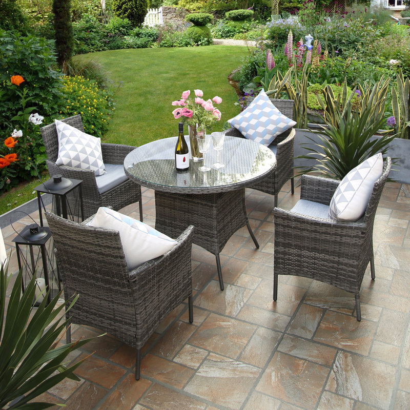 Twigg 4 - Person Premium All-Weather Wicker Patio Dining Set with Round Table , Cushions Included