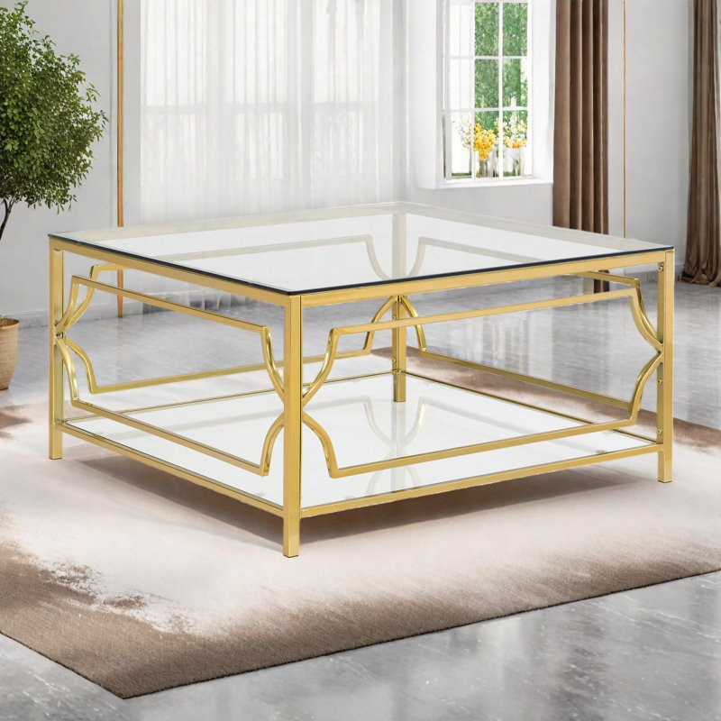 Table basse carrée en verre avec cadre géométrique en métal doré et tablette de rangement inférieure