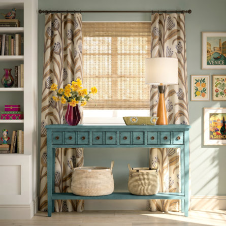 Blue console table with flowers, lamp, and Venice and Florence art prints.