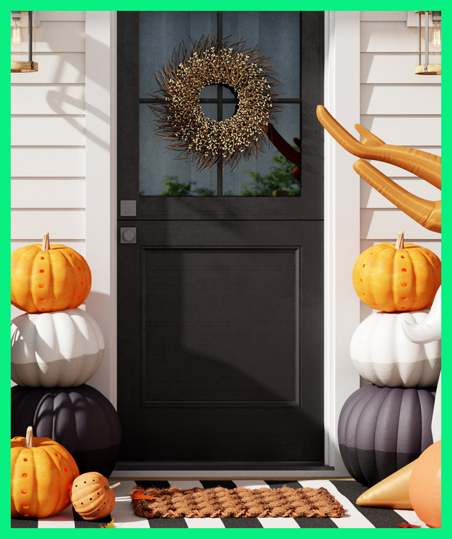 Halloween door decor with wreath and pumpkins.
