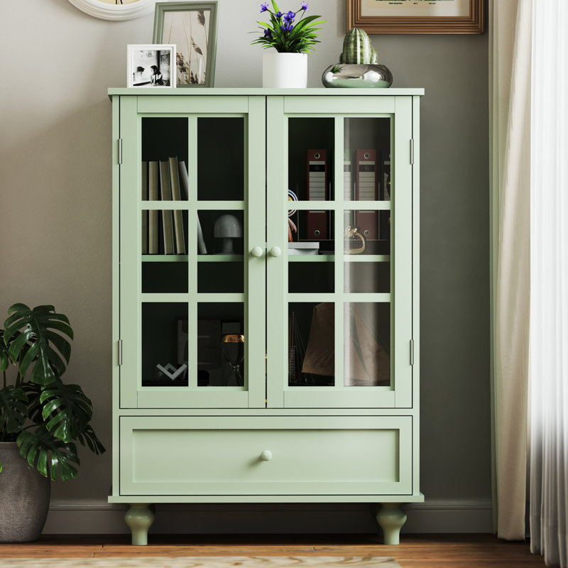 Armoire de salle à manger contemporaine avec portes et tiroir en verre double - menthe. Qualité fine, robustesse des pieds en bois massif, protection trempée. Tablette réglable, espace pratique.