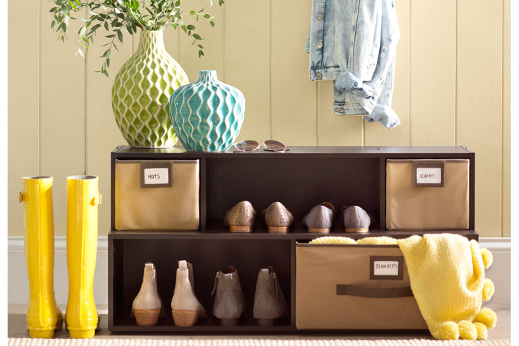 brown shoe shelf with labeled bins