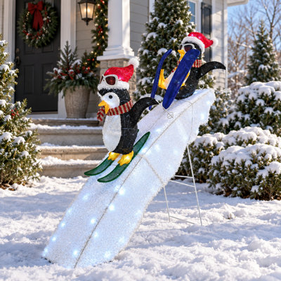 Duo de pingouins skieurs joueurs de 1,20 m sur une piste enneigée, décoration lumineuse extérieure de Noël avec 130 DEL