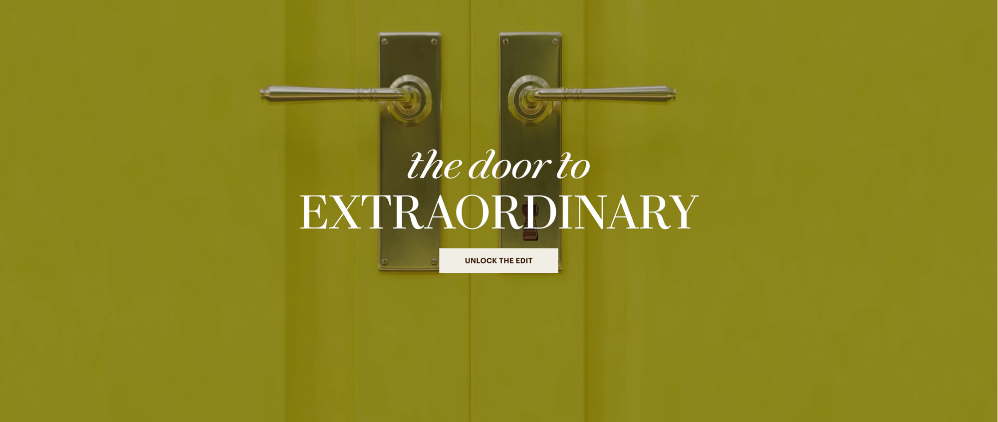 Bright yellow double doors with brass handles featuring the text the door to EXTRAORDINARY and a button labeled UNLOCK THE EDIT.