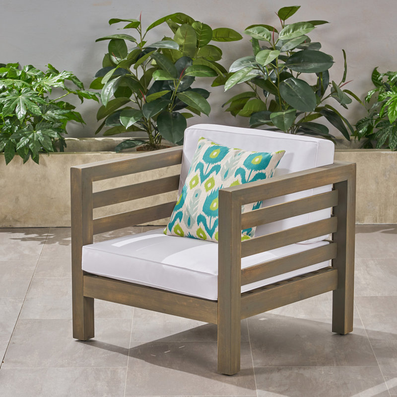 Fauteuil club en bois avec coussins rembourrés et imperméables