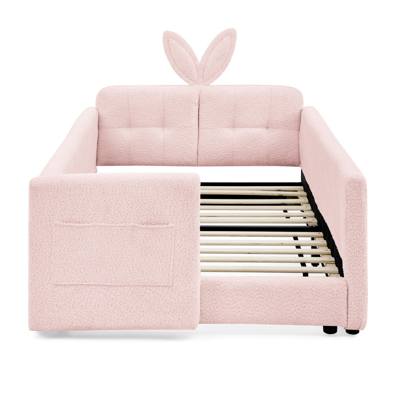 Lit simple tapissier à boucle simple rose, avec une jolie tête d'oreille de lapin, des panneaux et un espace de rangement pour la conception du lit