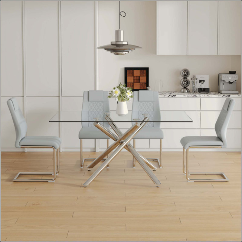 Ensemble de table de salle à manger moderne et luxueux en verre trempé avec 4 chaises en polyuréthane et des pieds en métal, parfait pour les expériences culinaires élégantes.