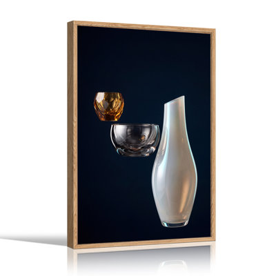 Vase blanc, bol transparent et tasse en verre à facettes ambrées sur toile bleu foncé