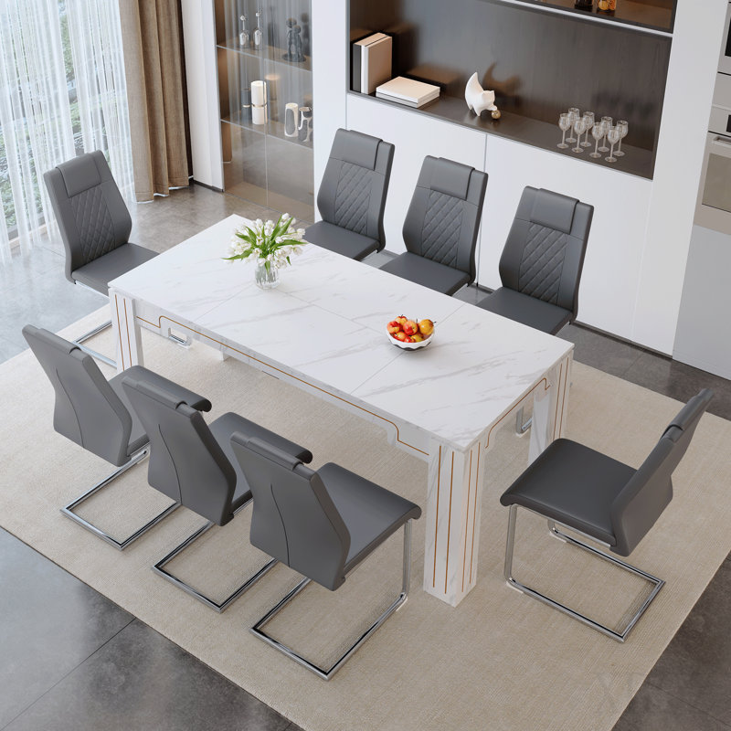 Ensemble de table et de chaises. Table de salle à manger 71 po x 31,5 po Jumelé avec 8 chaises en polyuréthane gris foncé avec des pieds en métal arqués argentés. Ce qui en fait un choix idéal pour les restaurants.