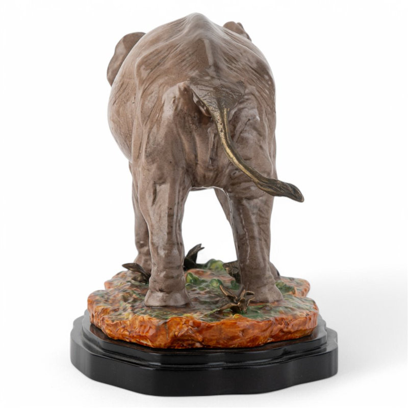 Porcelain Elephant Figurine With Bronze Tusks and Tail Accents On Wood Base