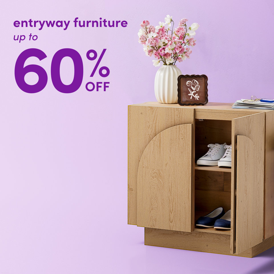 Entryway furniture up to 60% off, featuring a wooden storage cabinet with a vase of flowers on top against a light purple background.