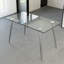 Table contemporaine en verre trempé pour la salle à manger et le bureau, structure simple et élégante avec quatre pieds en métal argenté