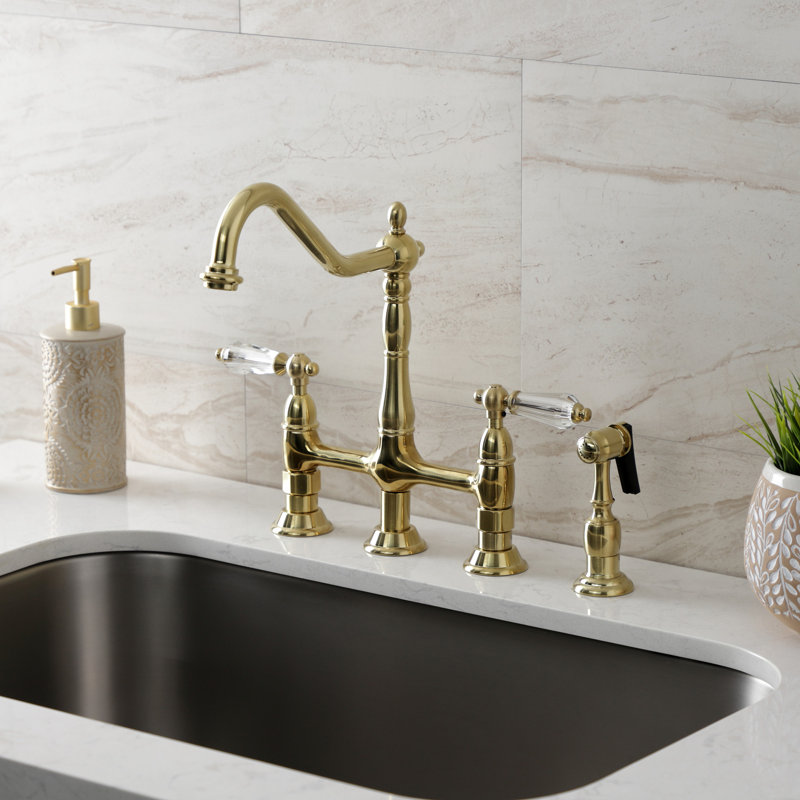 Kingston Brass Wilshire Two-Handle 4-Hole Deck Mount Bridge Kitchen Faucet with Side Sprayer, Brushed Brass