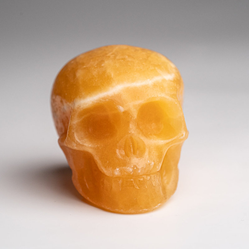 Polished Orange Calcite Skull Carving (127.4 Grams)