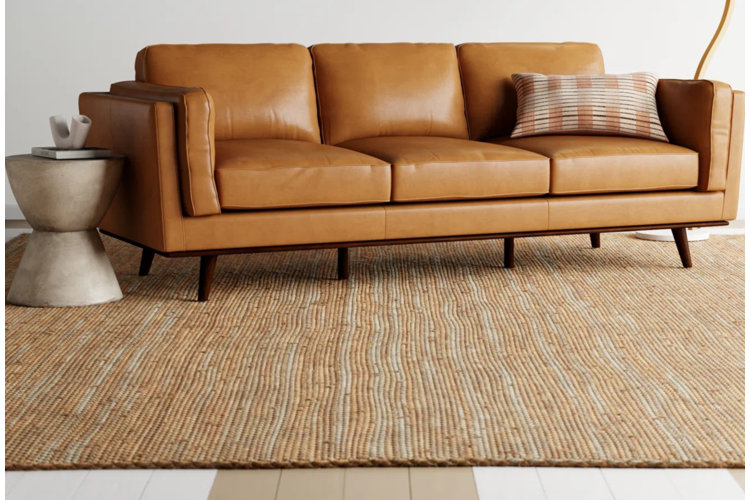 flatweave area rug made of natural fibers under a leather sofa in a modern living room