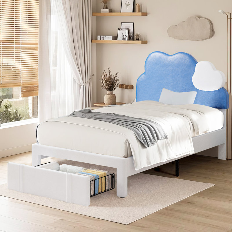 Lit simple tapissier avec tête de lit bleu et blanc et tiroirs de rangement sous le lit
