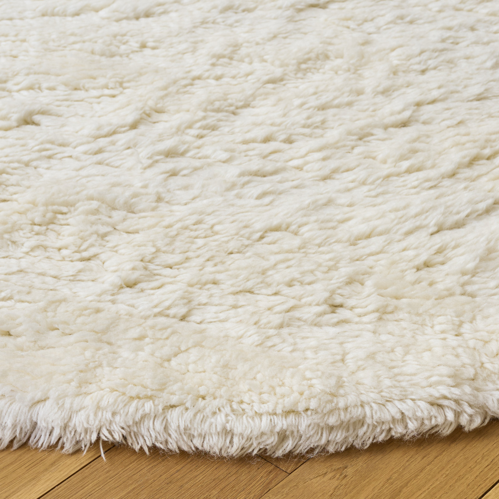 Abriel Ivory Solid Hand-Woven Wool Rug, Round 7'