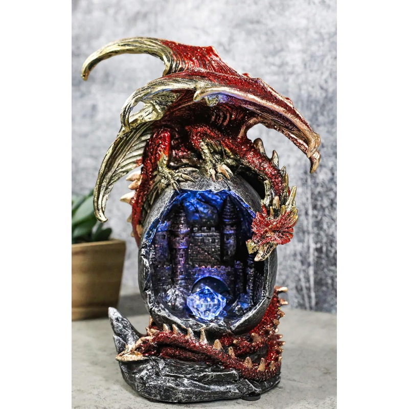 Figurine fantaisie en forme de dragon rouge sur un œuf géant à DEL avec château médiéval